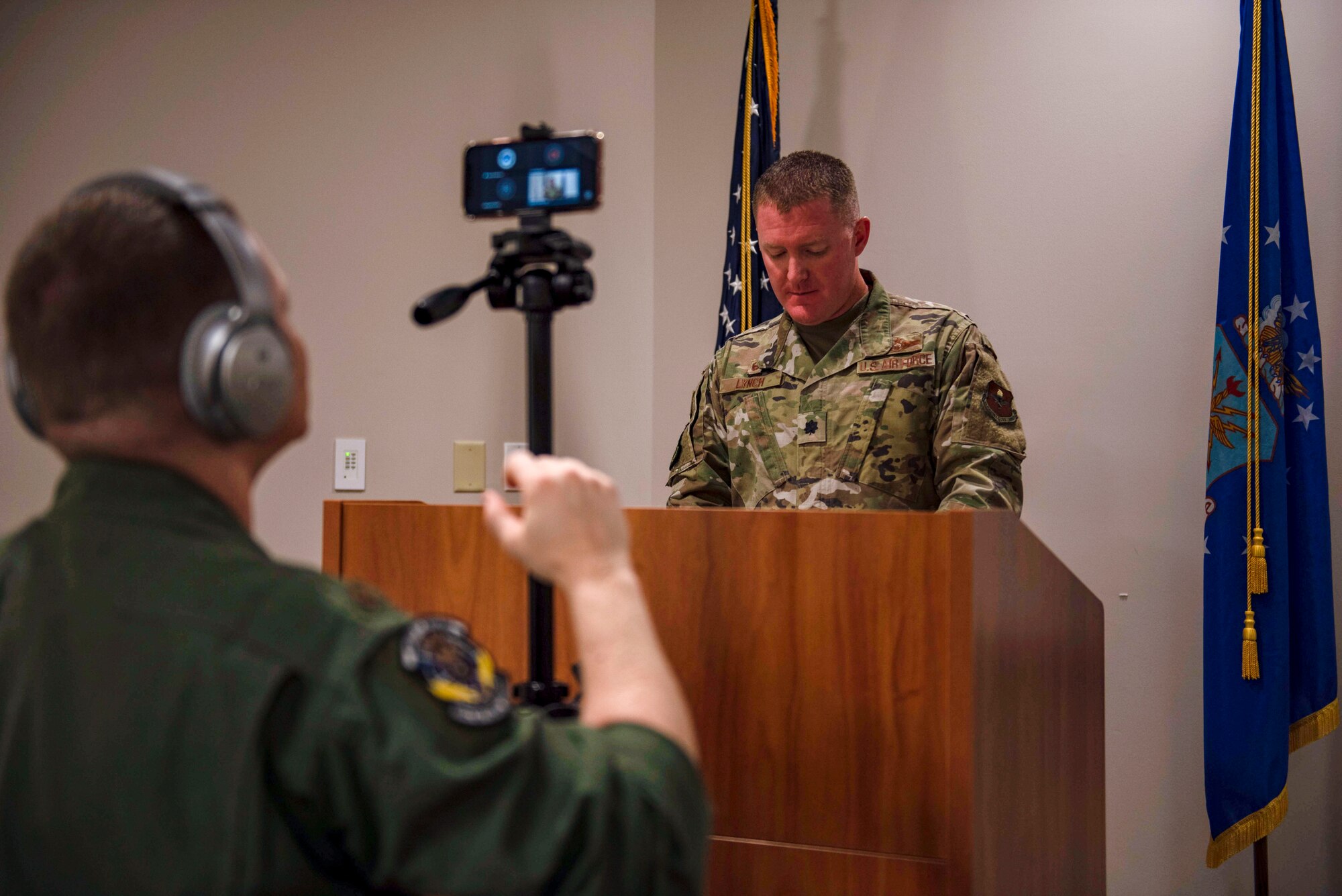 U.S. Air Force Maj. Jason Spicer, 337th Air Control Squadron, assistant director of operations, records U.S. Air Force Lt. Col. Michael Lynch, 337th ACS, commander, during a virtual ceremony held at the 337th ACS Air Battle Manager schoolhouse at Tyndall Air Force Base, Florida, May 26, 2020. The ceremony was held to honor the naming and dedication of Building 1285 after retired Gen. Lori Robinson who became the highest ranking ABM and the first female combatant commander in military history. (U.S. Air Force photo by Staff Sgt. Magen M. Reeves)