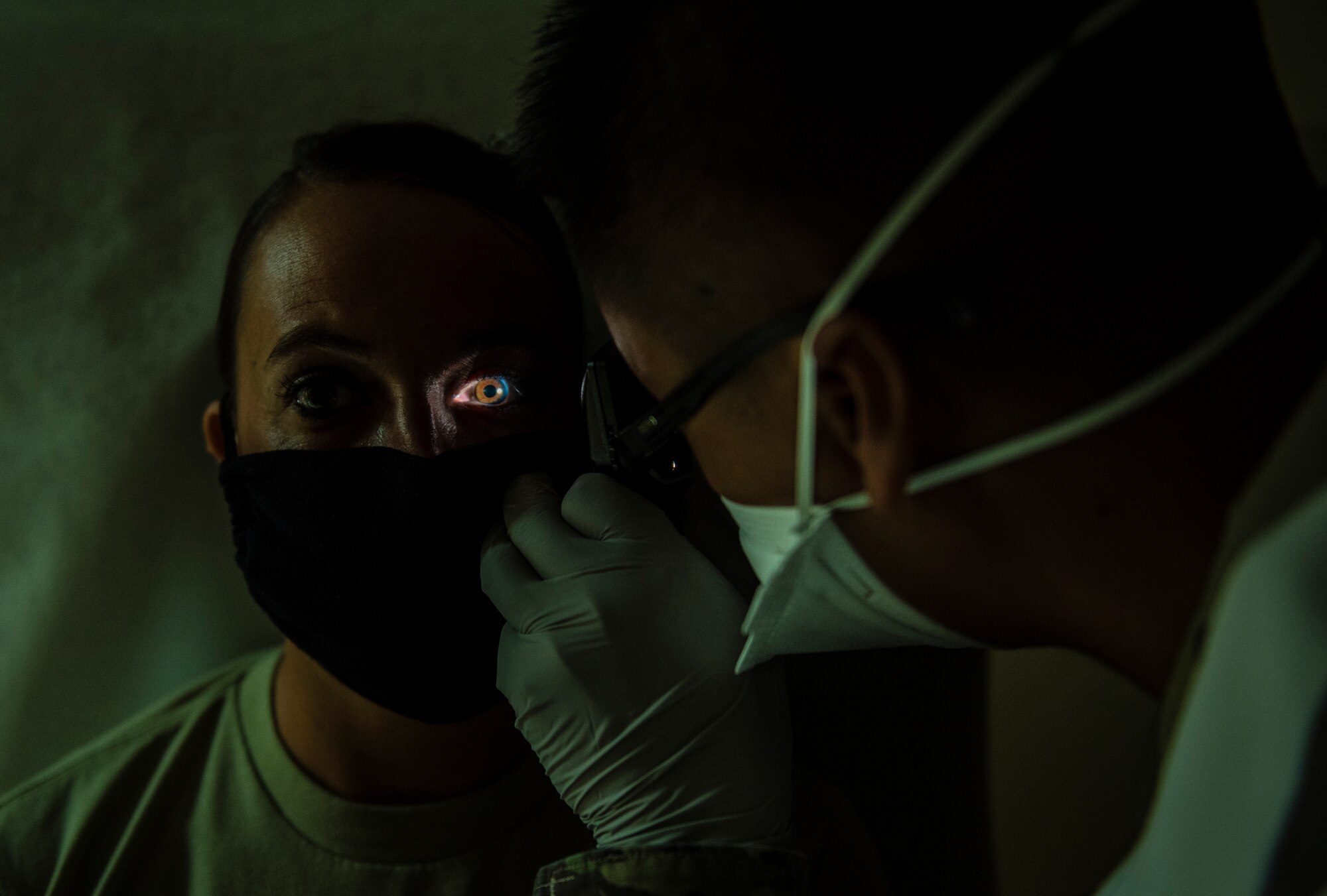 U.S. Air Force Capt. Everlino Ramos, 36th Medical Operations Squadron family health physician assistant, performs an eye exam on a patient at Andersen Air Force Base, Guam, May 16, 2020.