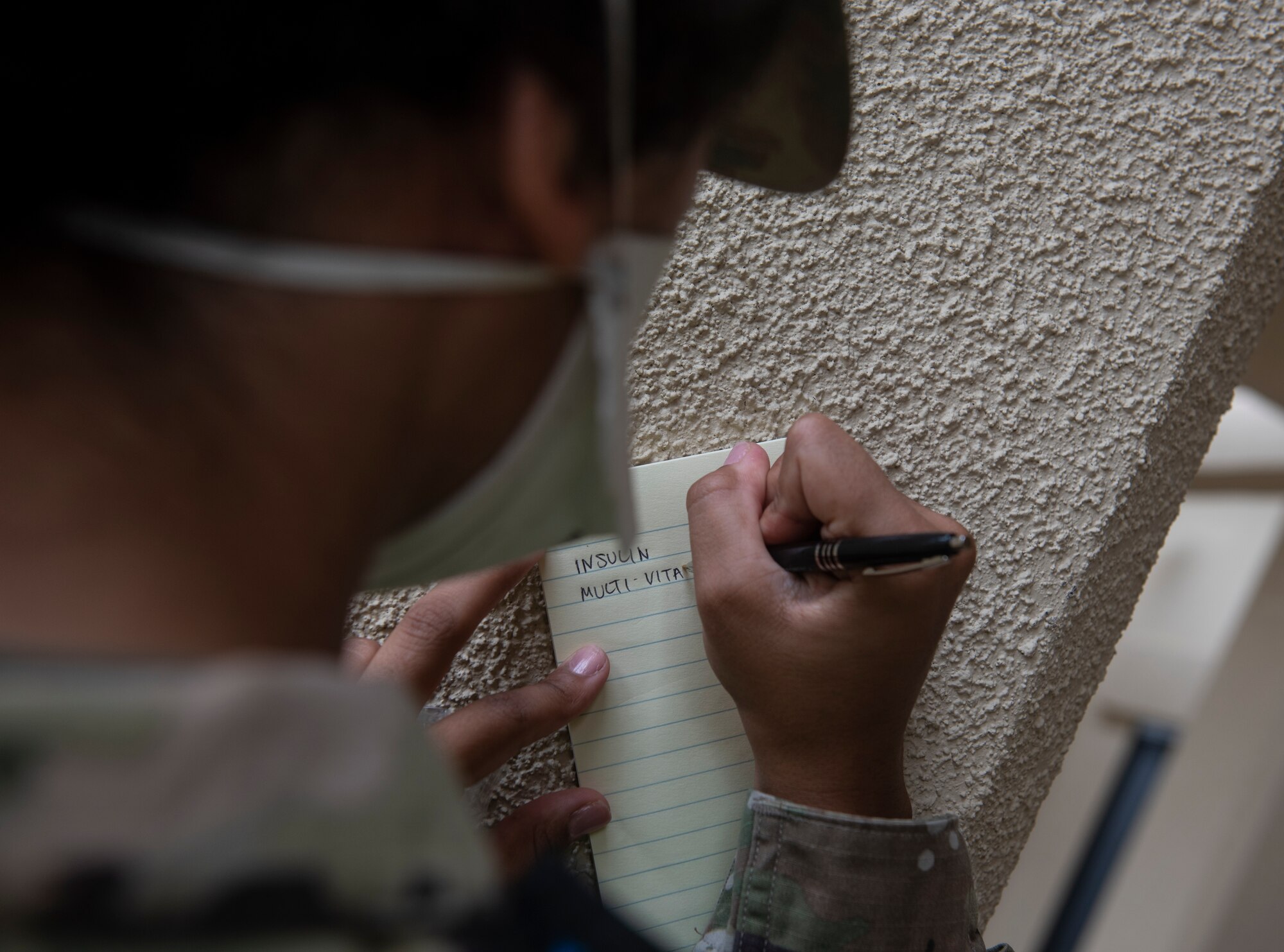 U.S. Air Force Senior Airman Patience Letourneau, 36th Medical Operations Squadron dental technician, writes down medication for a patient at Andersen Air Force Base, Guam, May 16, 2020.