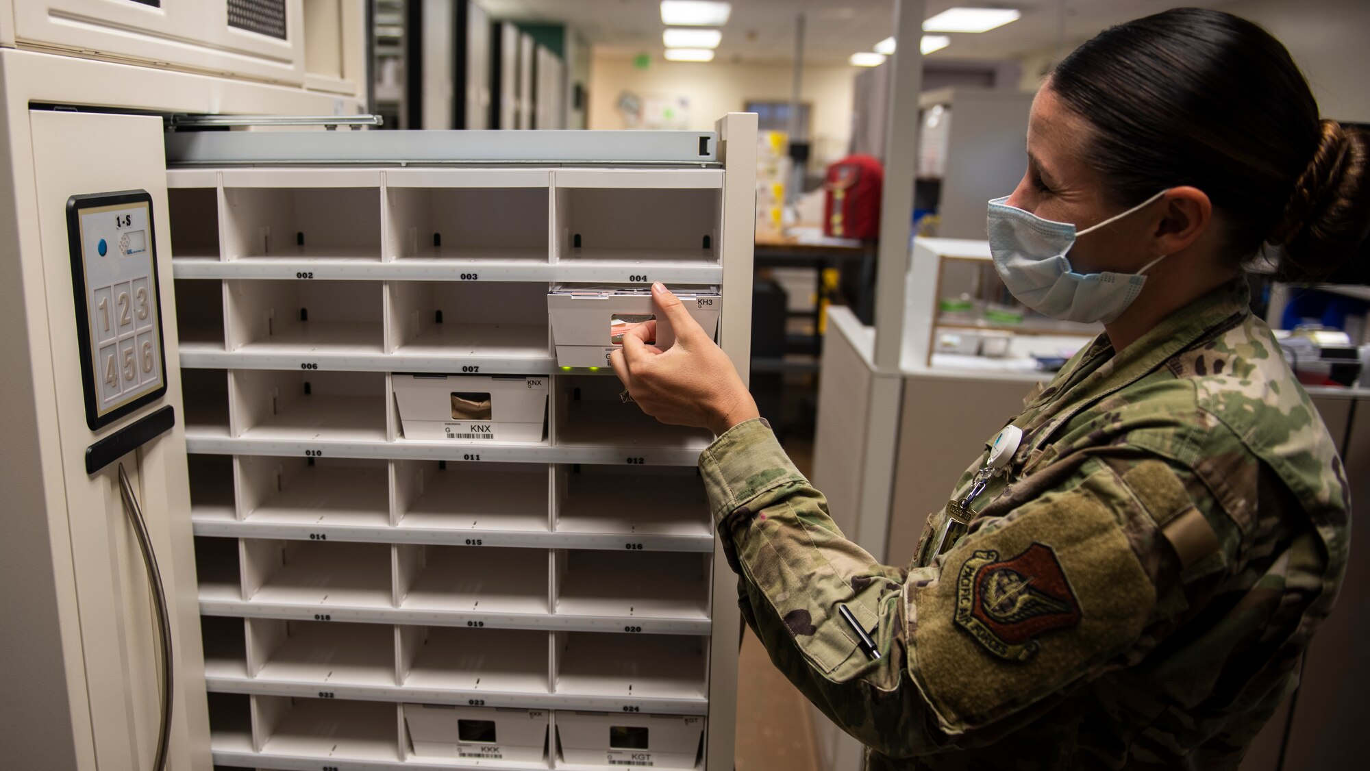 U.S. Air Force Tech Sgt. Amanda Dorsey, 36th Medical Support Squadron NCO in charge of pharmacy supply, pulls out medication for a patient at Andersen Air Force Base, Guam, May 16, 2020.
