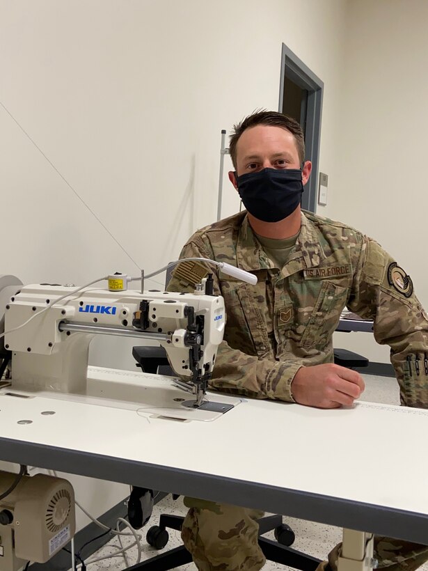 Tech. Sgt. Aaron McKeage, 514th Flight Test Squadron aircrew flight equipment technician, poses for a photo near his sewing station May 5, 2020, at Hill Air Force Base, Utah. McKeage made cloth face covers at home for his squadron in response to COVID-19 health risks. (courtesy photo)