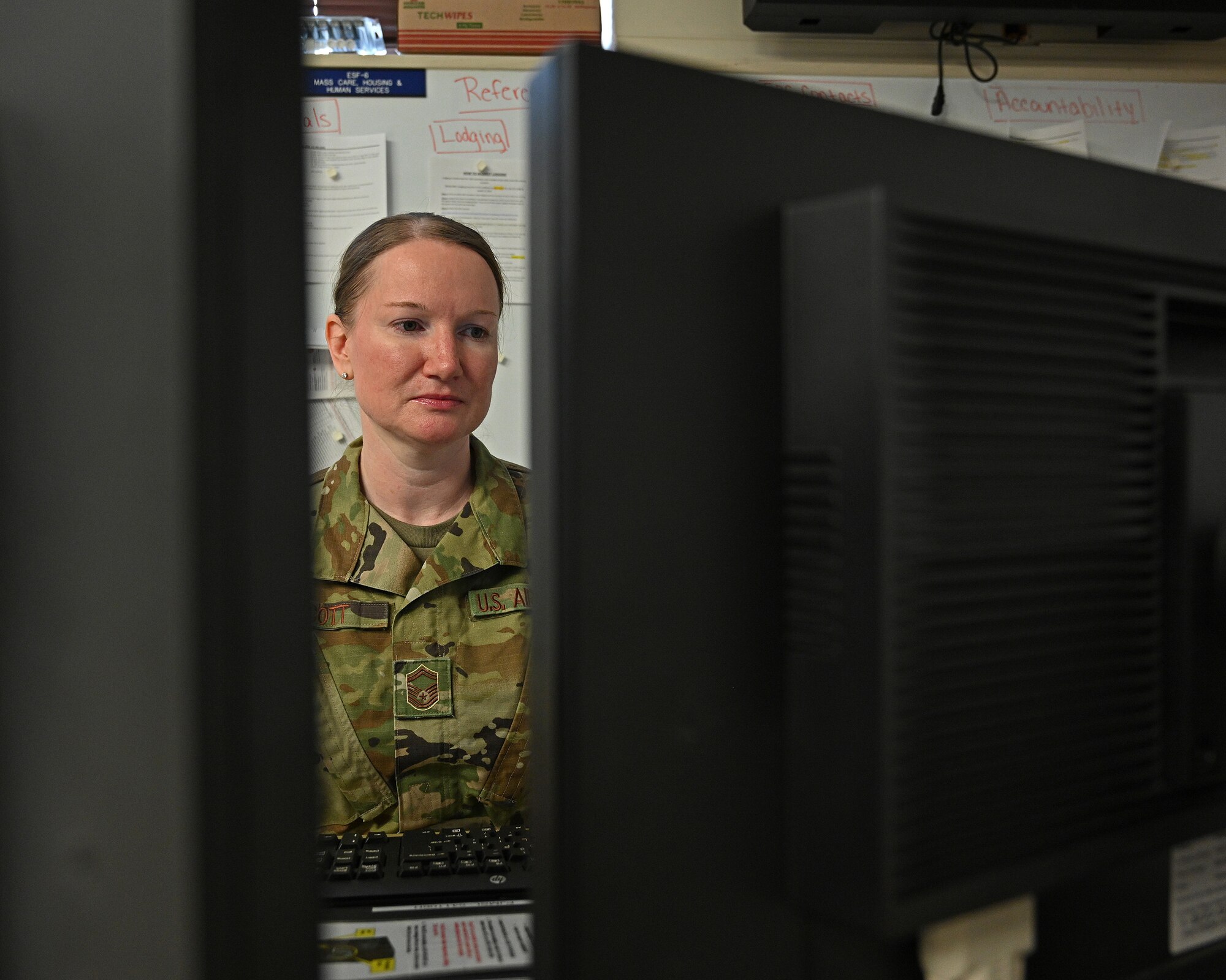 U.S. Air Force Senior Master Sgt. Stephanie Scott, 175th Wing Emergency Operations Center manager, sits at her computer in the Emergency Operations Center at Warfield Air National Guard Base, Middle River, Md., May 21, 2020. The 175th Wing established the EOC during the state's response to the COVID-19 pandemic.