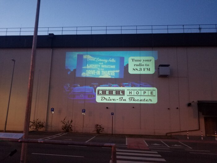Image of a screen for a makeshift drive-in movie theater.