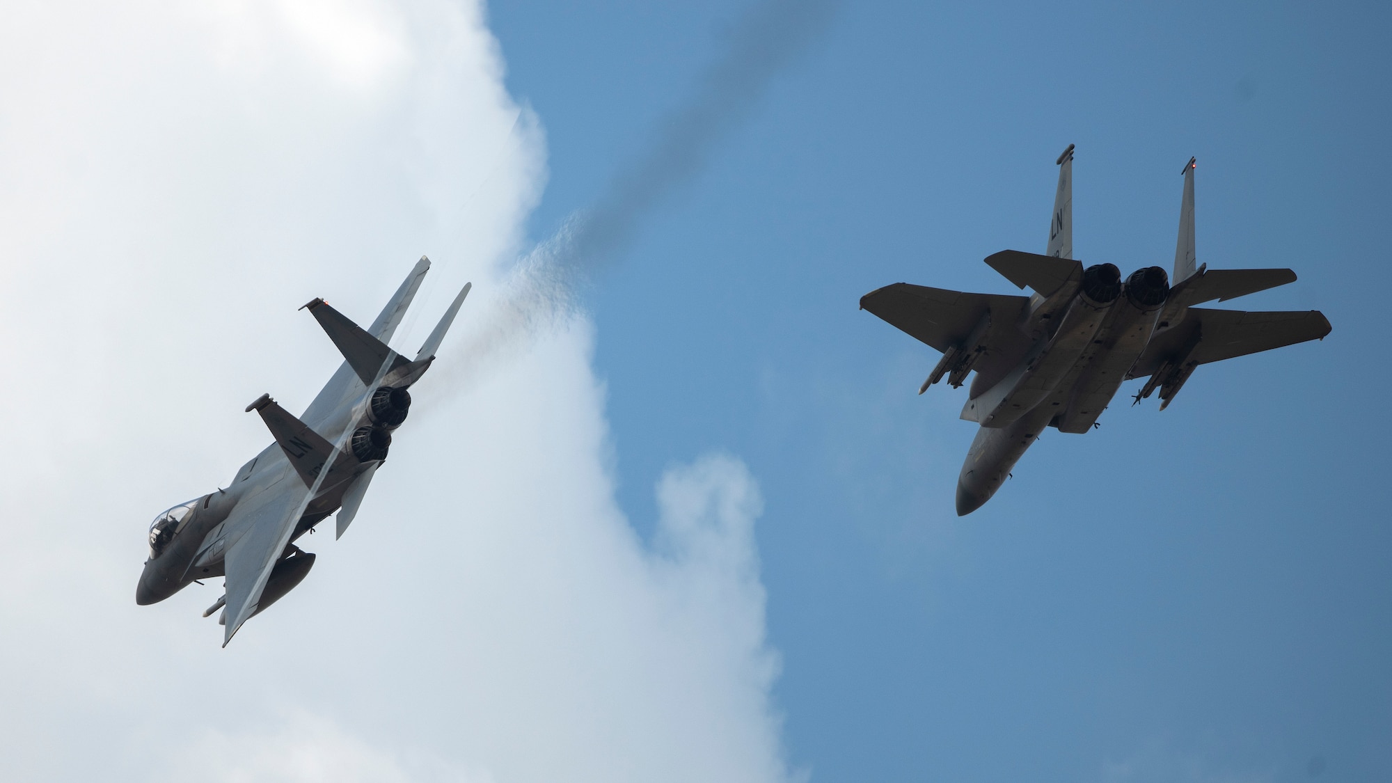 Two F-15C Eagles assigned to the 493rd Fighter Squadron fly over Royal Air Force Lakenheath, England, May 20, 2020. The 493rd FS conducts routine training to ensure the Liberty Wing brings unique air combat capabilities to the fight when called upon by U.S. Air Forces in Europe-Air Forces Africa. (U.S. Air Force photo by Airman 1st Class Jessi Monte)