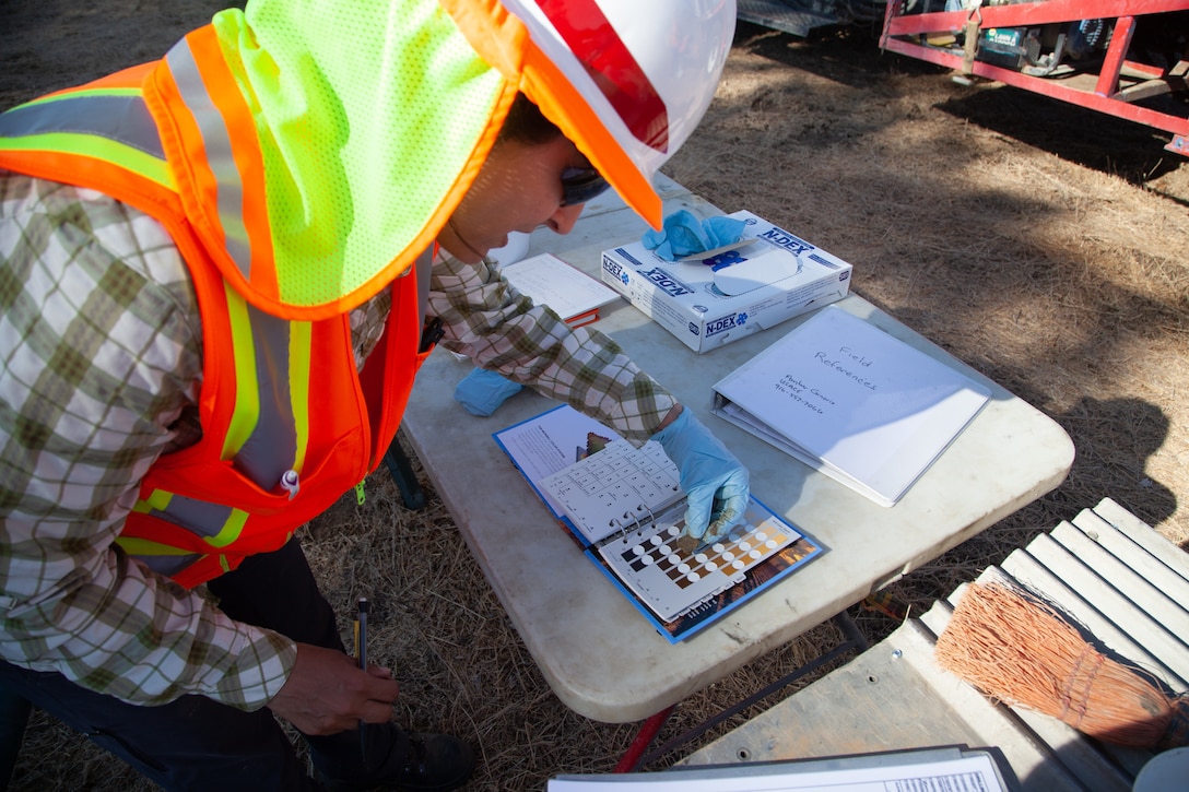 Amber Ginorio, a geologist with the U.S. Army Corps of Engineers Sacramento District, examines samples of soil near a defunct U.S. Air Force Titan missile silo in Lincoln, Calif., on Aug. 14, 2019.