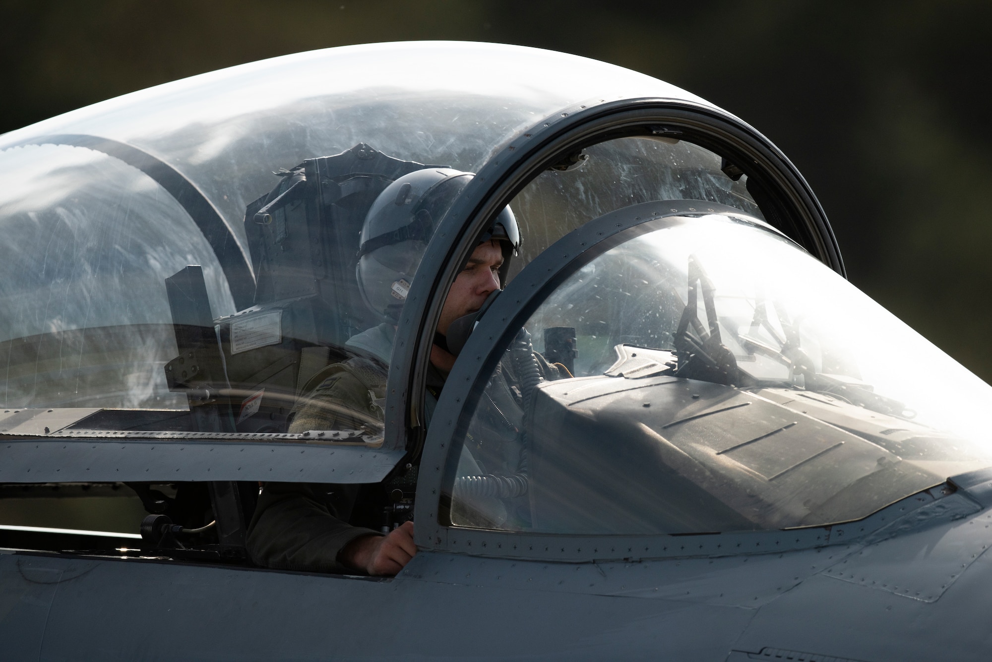 A pilot assigned to the 493rd Fighter Squadron waits while his F-15C Eagle is refueled at the "hot pits" at Royal Air Force Lakenheath, England, May 20, 2020. “Hot pit” refueling provides necessary training and experience required to reduce the ground time between sorties by refueling active aircraft, enabling maximum training in a shorter time frame. (U.S. Air Force photo by Airman 1st Class Jessi Monte)