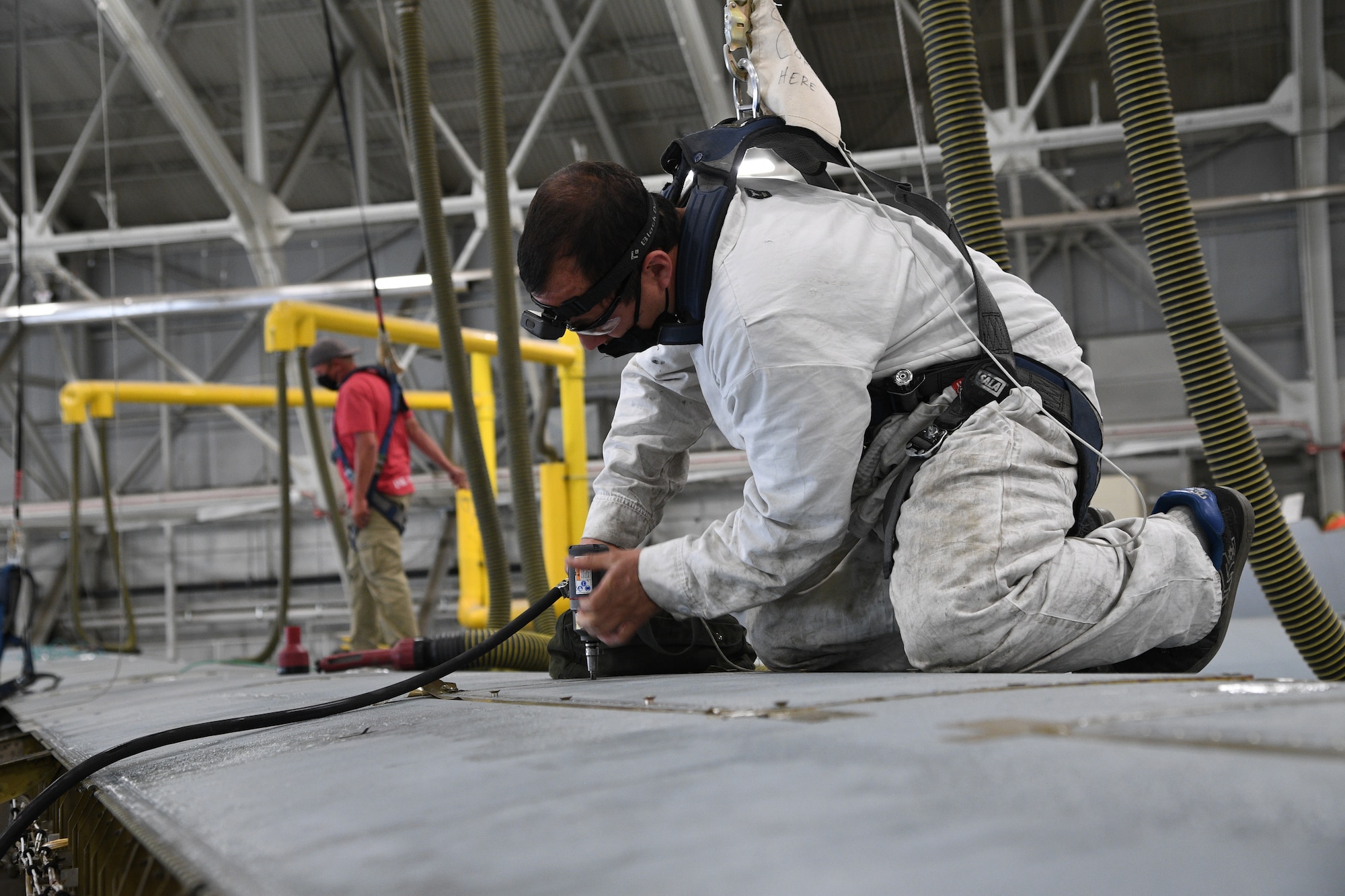 Jon Pena, 309th Aircraft Maintenance Group pneudraulic systems mechanic, removes a panel from a C-130 wing at Hill Air Force Base, Utah, May 8, 2020. Comprised of seven maintenance squadrons and more than 2,000 personnel, the 309th AMXG performs depot maintenance, repair and overhaul on A-10, C-130, F-16, F-22, F-35 and T-38 airframes. (U.S. Air Force photo by R. Nial Bradshaw)