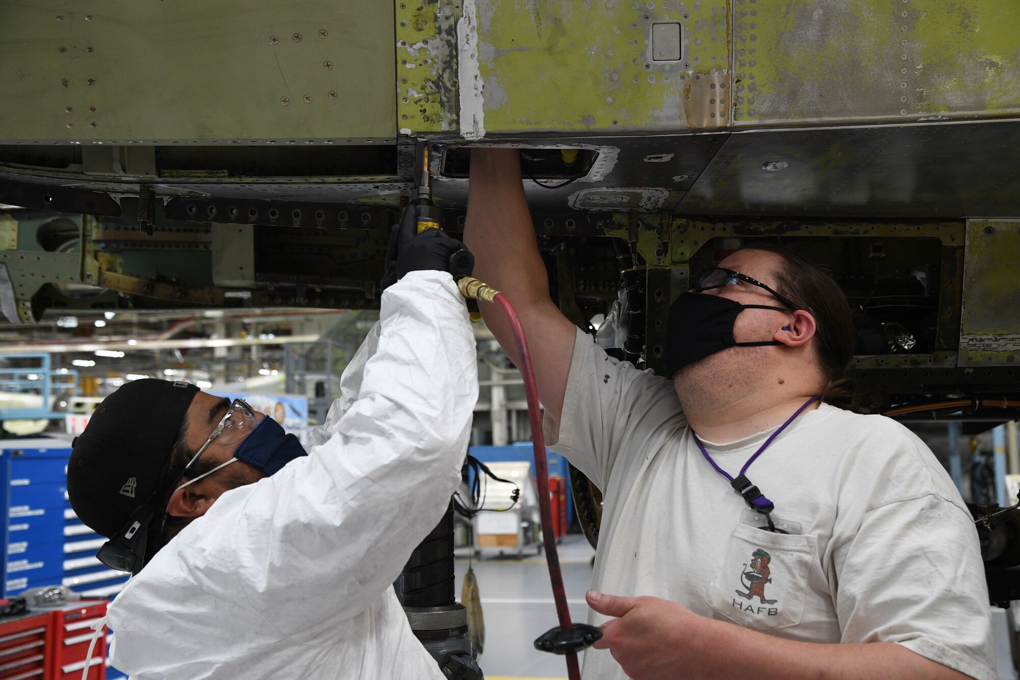 Juan Gutierrez, left, and Jeff Schmitt, 309th Aircraft Maintenance Group sheet metal mechanics, work on an F-16 at Hill Air Force Base, Utah, May, 8, 2020. Comprised of seven maintenance squadrons and more than 2,000 personnel, the 309th AMXG performs depot maintenance, repair and overhaul on A-10, C-130, F-16, F-22, F-35 and T-38 airframes. (U.S. Air Force photo by R. Nial Bradshaw)
