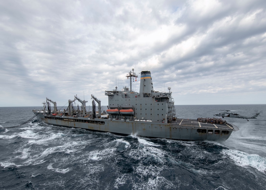 An MH-60S Sea Hawk helicopter, assigned to the "Tridents" of Helicopter Sea Combat Squadron 9, lifts supplies off the flight deck of USNS Patuxent during a vertical replenishment with USS Gerald R. Ford (CVN 78) May 15.