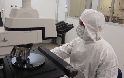 iles Owen, a metrologist with the Army Primary Standards Laboratory, counts aerosol particles deposited onto a silicon wafer in the APSL clean room. The measurement is part of a research project to calibrate particle counters using large aerosol particles in the size range of bacteria, with application to environmental monitors and biological defense sensors.