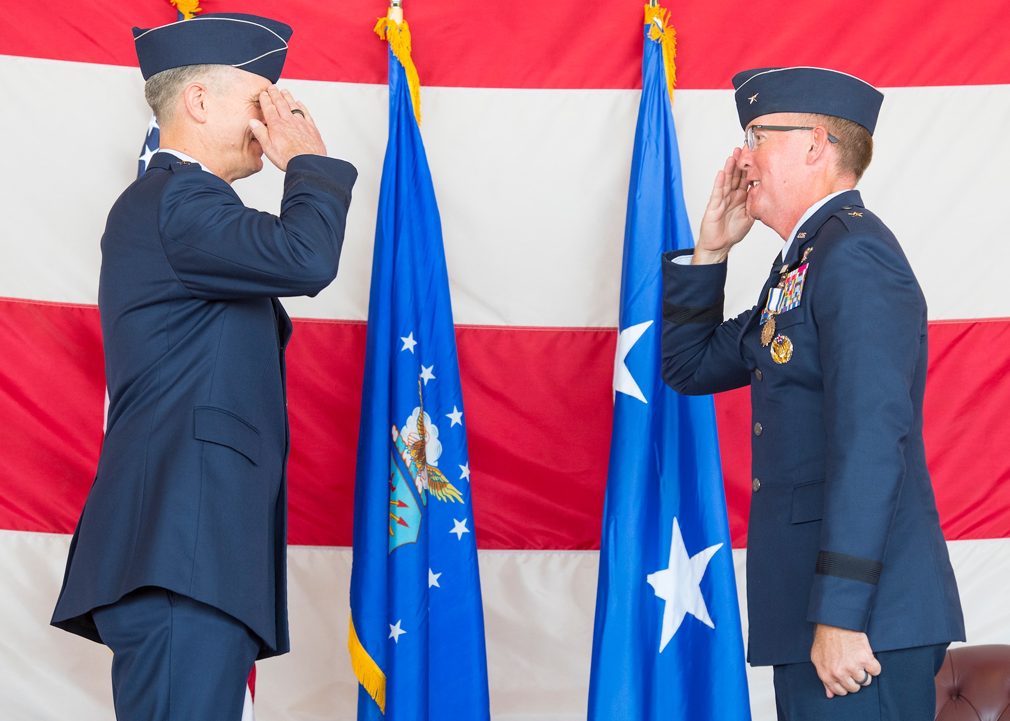 Brig. Gen. Todd Canterbury, 56th Fighter Wing outgoing commander (right), salutes Maj. Gen. Craig Wills, 19th Air Force commander, Joint Base San Antonio-Randolph, Texas, May 27, 2020, during the 56th FW Change of Command ceremony at Luke Air Force Base, Ariz.
