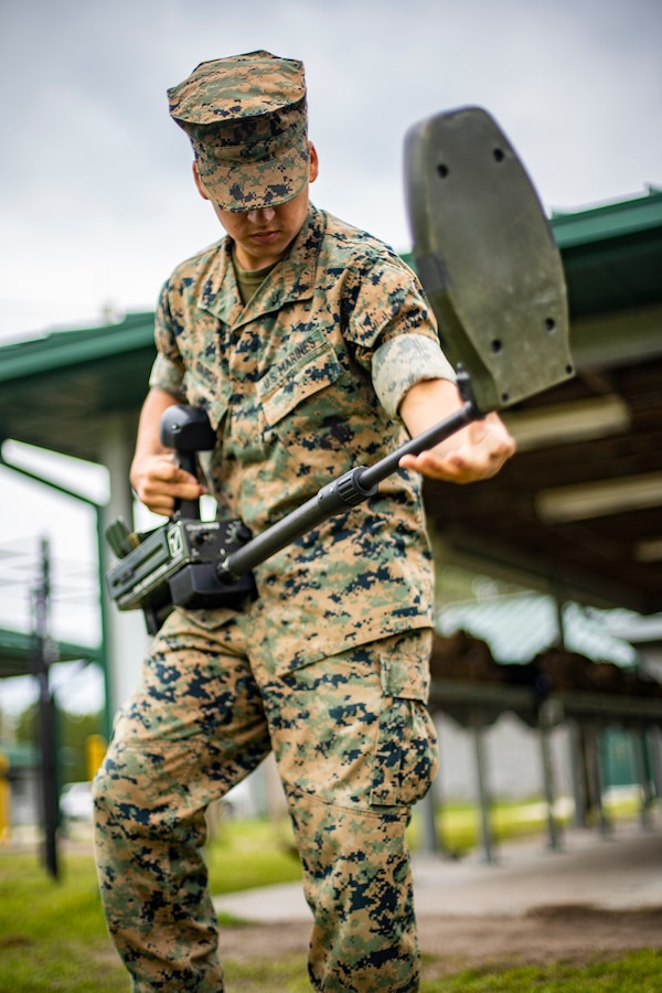 Lance Cpl. Ian Garcia, a combat engineer with Special Purpose Marine Air-Ground Task Force - Southern Command, calibrates a metal detector during a certification exercise at Marine Corps Base Camp Lejeune, North Carolina, April 23, 2020. The CERTEX is the culmination exercise that will test the training and readiness of the Marines and Sailors of the SPMAGTF-SC for certification to deploy. Once certified, the SPMAGTF-SC will be ready to conduct crisis response, theater security cooperation training and general engineering projects alongside partner nation militaries in Latin America and the Caribbean. Garcia is a native of Wilsonville, Oregon. (U.S. Marine Corps photo by Sgt. Andy O. Martinez)