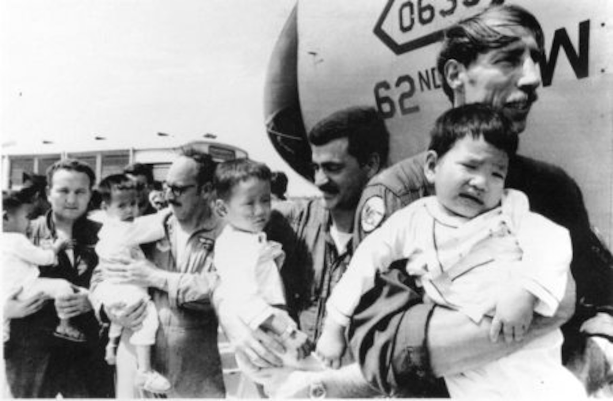 62nd Military Airlift Wing service members carry orphaned children during Operation Babylift, April, 1975.
