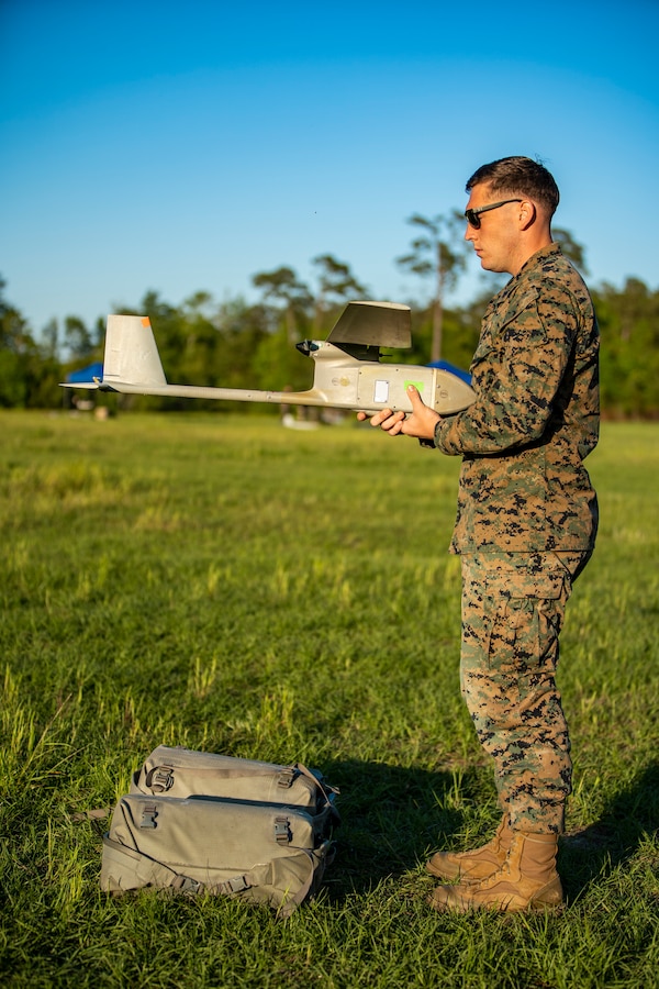 Cpl. Tryston Compton, a geospatial intelligence analyst with Special Purpose Marine Air-Ground Task Force - Southern Command, conducts pre-flight checks during an RQ-11B Raven Operator Course at Marine Corps Base Camp Lejeune, North Carolina, April 27, 2020. SPMAGTF-SC Marines participated in the course to test their knowledge and skills when employing a small unmanned aircraft system. Marines and Sailors with SPMAGTF-SC are conducting a variety of pre-deployment training events and qualifications in order to enhance crisis response preparedness. These events assist the Marines and Sailors with providing security cooperation training and engineering projects alongside partner nation military forces in Latin America and the Caribbean. Compton is a native of Fort Collins, Colorado. (U.S. Marine Corps photo by Sgt. Andy O. Martinez)
