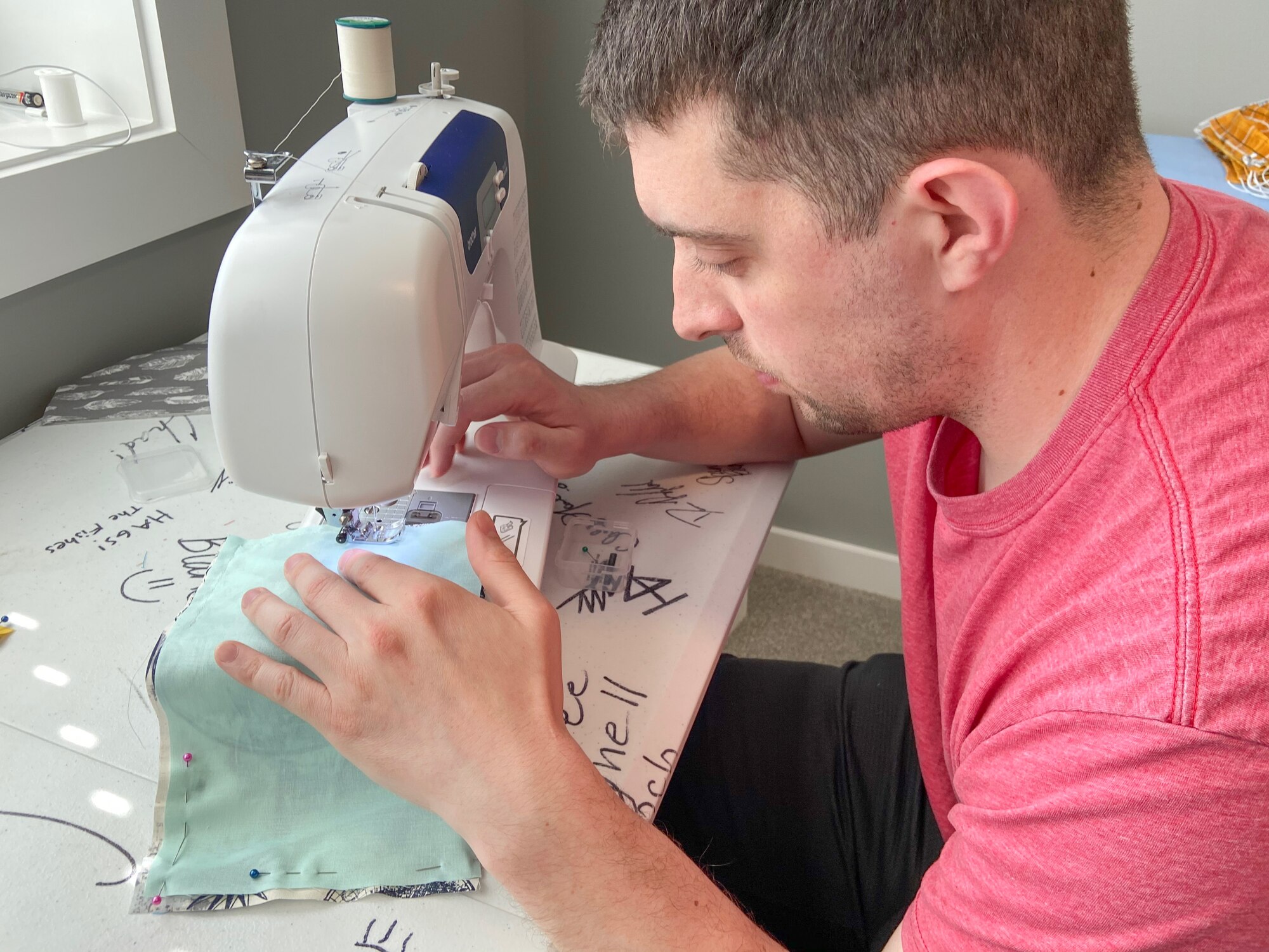 U.S. Air Force Capt. Ben Kram, a 393rd Bomb Squadron pilot, sews a face mask on May 13, 2020, at Whiteman Air Force Base, Missouri.