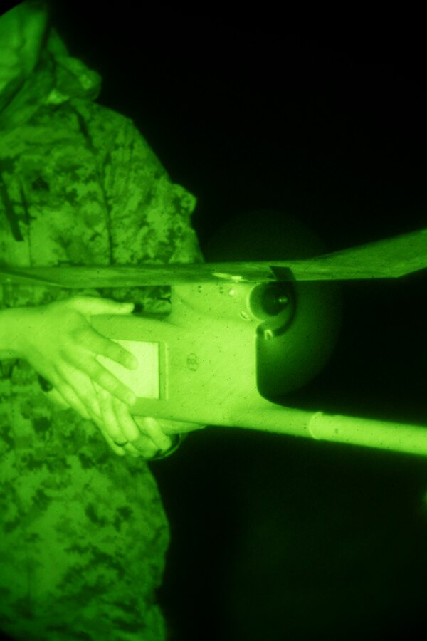 Sgt. Adrian Ortiz, an intelligence analyst with Special Purpose Marine Air-Ground Task Force - Southern Command, conducts pre-flight checks during an RQ-11B Raven Operator Course at Marine Corps Base Camp Lejeune, North Carolina, April 27, 2020. SPMAGTF-SC Marines participated in the course to test their knowledge and skills when employing a small unmanned aircraft system. Marines and Sailors with SPMAGTF-SC are conducting a variety of pre-deployment training events and qualifications in order to enhance crisis response preparedness. These events assist the Marines and Sailors with providing security cooperation training and engineering projects alongside partner nation military forces in Latin America and the Caribbean. Ortiz is a native of Albuquerque, New Mexico. (U.S. Marine Corps photo by Sgt. Andy O. Martinez)