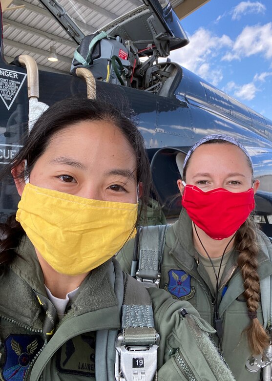 U.S. Air Force Capts. Lauren Kram and Lacey Orians, 393rd Bomb Squadron pilots, prepare to enter a T-38 Talon on May 13, 2020, at Whiteman Air Force Base, Missouri. Lauren and her husband Capt. Ben Kram, a 393rd BS pilot, created and donated over 500 masks nationwide to military bases, hospitals, and nursing homes to help minimize the spread of COVID-19.