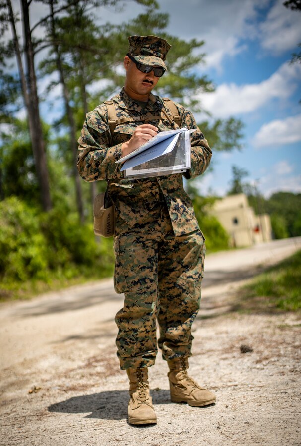 Sgt. Justin Cortez, a civil affairs specialist with Special Purpose Marine Air-Ground Task Force - Southern Command, records his pace count during land navigation training at Camp Lejeune, North Carolina, May 4, 2020. Land navigation consists of being able to use skills that can help one traverse through unfamiliar terrain by foot or in a vehicle. Marines and Sailors with SPMAGTF-SC are conducting a variety of pre-deployment training events and qualifications to enhance crisis response readiness. These events assist the Marines and Sailors with providing humanitarian aid assistance and engineering projects alongside partner nation military forces in Latin America and the Caribbean. Cortez is a native of Miami, Florida. (U.S. Marine Corps photo by Sgt. Andy O. Martinez)