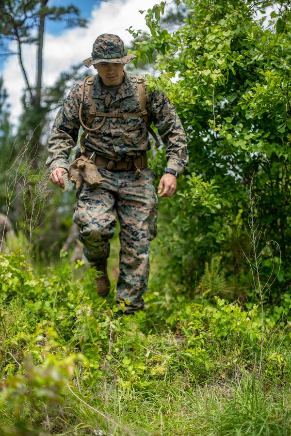 Sgt. David Mitchell, a military policeman with Special Purpose Marine Air-Ground Task Force - Southern Command, conducts a pace count on disrupted terrain during land navigation training at Camp Lejeune, North Carolina, May 4, 2020. Land navigation consists of being able to use skills that can help one traverse through unfamiliar terrain by foot or in a vehicle. Marines and Sailors with SPMAGTF-SC are conducting a variety of pre-deployment training events and qualifications to enhance crisis response readiness. These events assist the Marines and Sailors with providing humanitarian aid assistance and engineering projects alongside partner nation military forces in Latin America and the Caribbean. Mitchell is a native of Brewster, New York. (U.S. Marine Corps photo by Sgt. Andy O. Martinez)
