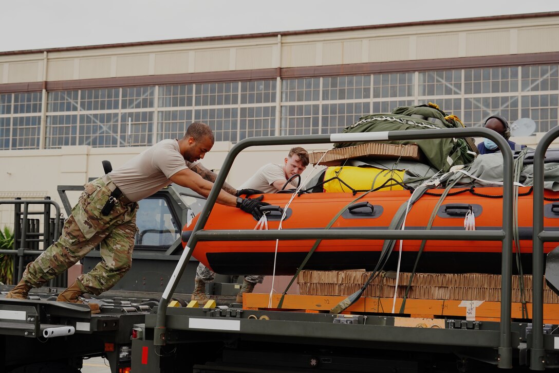 U.S. Air Force Staff Sgt. Micah Lowe, 647th Logistics Readiness Squadron load planning specialist and Staff Sgt. Waite Rowland, 647th Logistics Readiness Squadron combat mobility supervisor, move cargo onto loading trucks on the flightline on Joint Base Pearl Harbor-Hickam, Hawaii, May 26, 2020. In preparation for the historic launch of NASA’s SpaceX Demonstration Mission 2, several units from Team Hickam assisted the deployment of U.S. Air Force Guardian Angel Pararescue forces from the 58th Rescue Squadron, Nellis Air Force Base, Nevada as part of Task Force 45, facilitated by 45th Operations Group, Detachment 3, Human Space Flight Support located at Patrick Air Force Base, Florida. (U.S. Air Force photo by Airman 1st Class Erin Baxter)