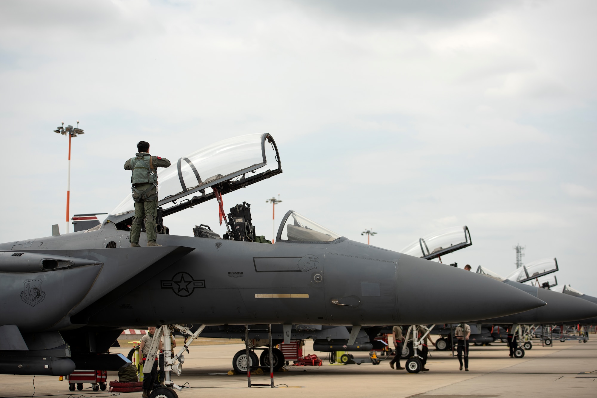 48th Fighter Wing aircrew and Airmen prepare F-15E Strike Eagles prior to takeoffs at Royal Air Force Lakenheath, England, May 27, 2020. U.S. Air Force F-15s assigned to the 48th Fighter Wing, F-16s assigned to the 31st Fighter Wing and 52nd Fighter Wing, and KC-135s assigned to the 100th Air Refueling Wing participated in a large force exercise within the U.K. North Sea airspace. (U.S. Air Force photo by Airman 1st Class Jessi Monte)