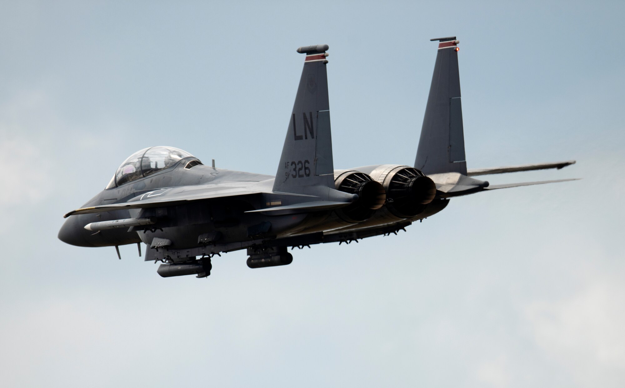 An F-15E Strike Eagle assigned to the 494th Fighter Squadron flies over Royal Air Force Lakenheath, England, May 27, 2020. During a large force exercise with other U.S. Air Forces in Europe-Air Forces Africa units, 48th Fighter Wing aircrew conducted Dissimilar Air Combat Training in order to enhance combat readiness and increase tactical proficiency needed to maintain a ready force capable of ensuring the collective defense of the NATO alliance. (U.S. Air Force photo by Airman 1st Class Jessi Monte)