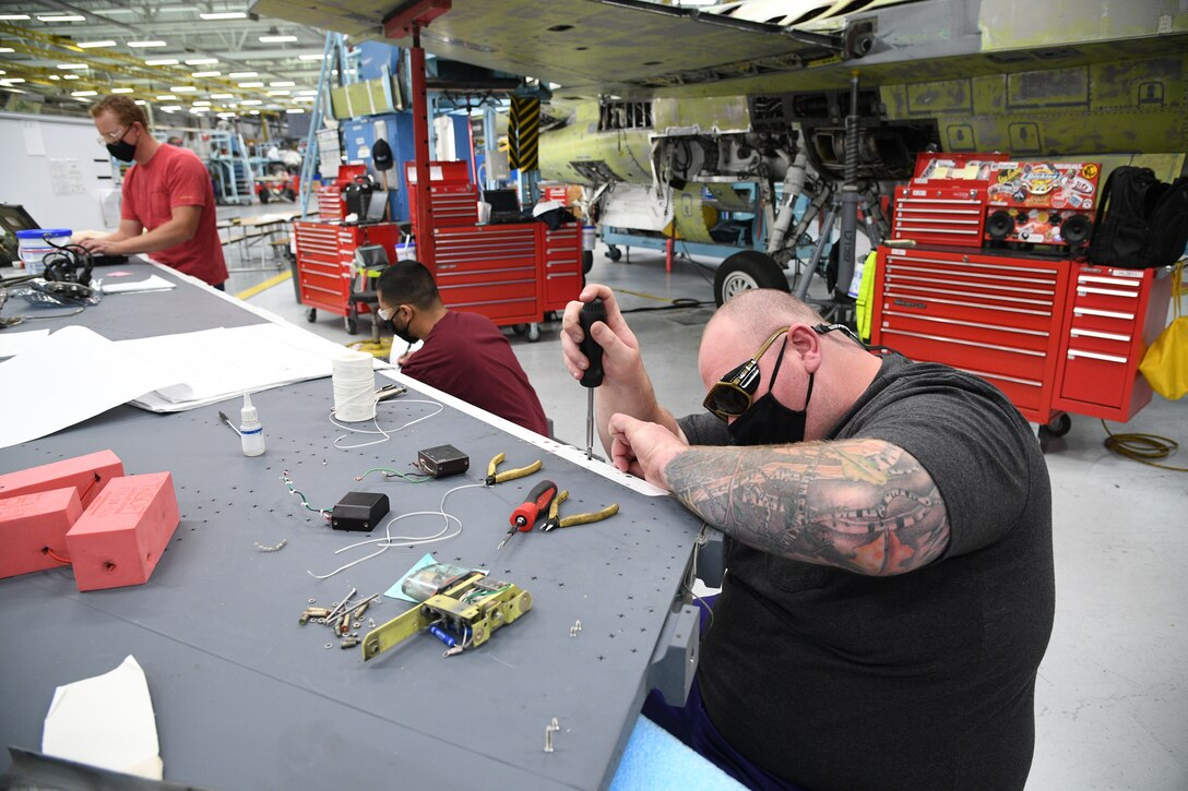 John Blessant, 309th Aircraft Maintenance Group electrician, intalls a wiring harness on an F-16 wing at Hill Air Force Base, Utah, May 8, 2020. Comprised of seven maintenance squadrons and more than 2,000 personnel, the 309th AMXG performs depot maintenance, repair and overhaul on A-10, C-130, F-16, F-22, F-35 and T-38 airframes. (U.S. Air Force photo by R. Nial Bradshaw)