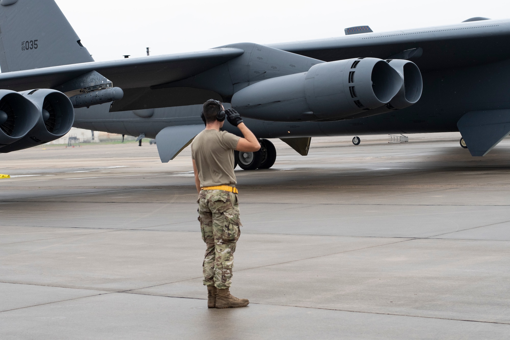 Photo of Airman saluting outgoing B-52 Stratofortress