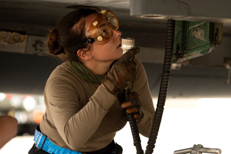 A crew chief assigned to the 492nd Fighter Squadron Aircraft Maintenance Unit services the engine of an F-15E Strike Eagle at Royal Air Force Lakenheath, England, May 27, 2020. During a large force exercise with other U.S. Air Forces in Europe-Air Forces Africa units, 48th Fighter Wing aircrew conducted Dissimilar Air Combat Training in order to enhance combat readiness and increase tactical proficiency needed to maintain a ready force capable of ensuring the collective defense of the NATO alliance. (U.S. Air Force photo by Airman 1st Class Jessi Monte)