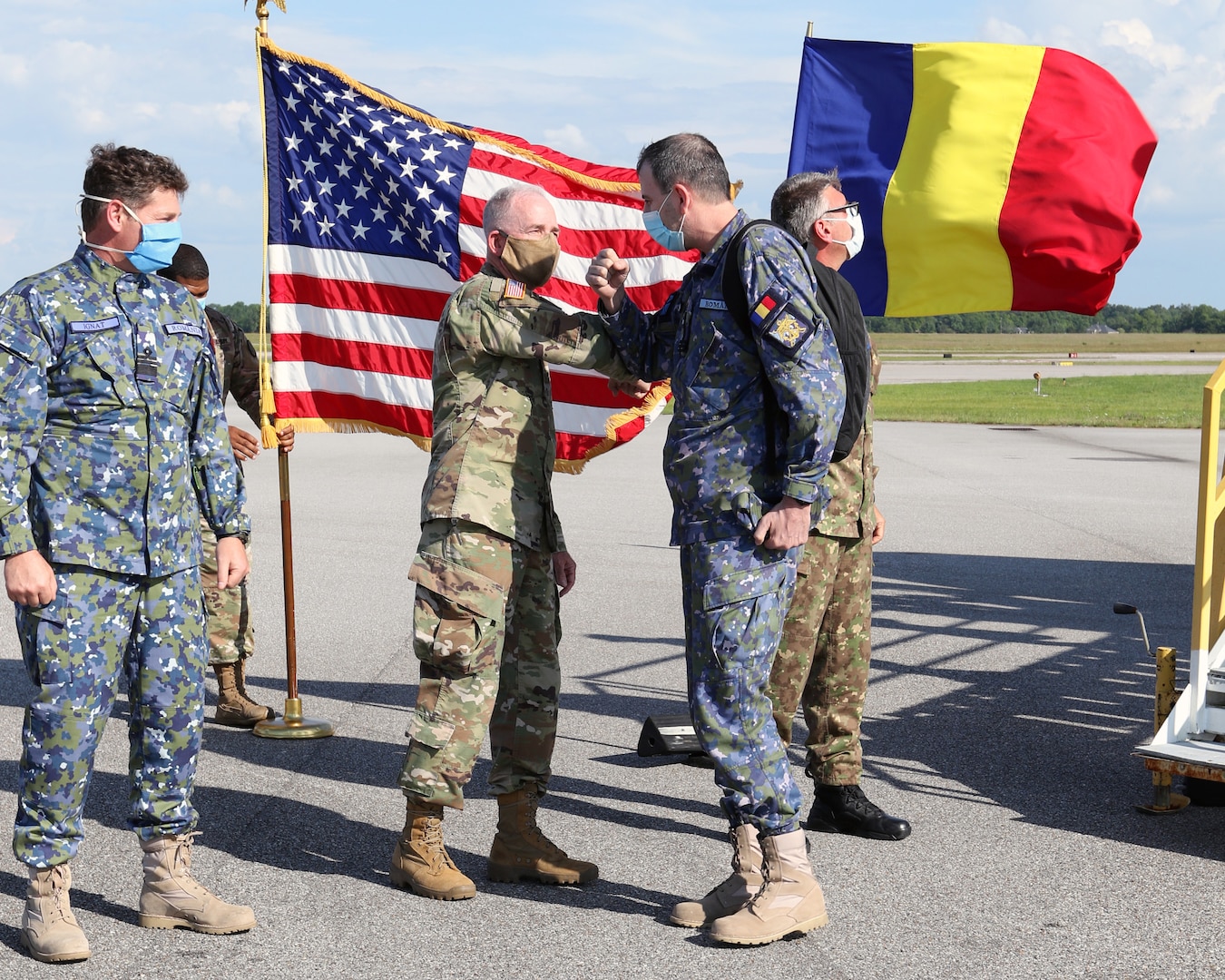 Col. Michael J. Rowland, Alabama state surgeon, commander Medical Detachment, Army National Guard, welcomes Col. Teodor Aurelian, SPÂNU, branch chief, National Military Command Bucuresti, May 25, 2020, at Montgomery Aviation, Montgomery, Alabama. Romania sent 15 military medical and other experts to assist the U.S. domestic COVID-19 response. Romania and Alabama are partners under the National Guard Bureau's State Partnership Program.