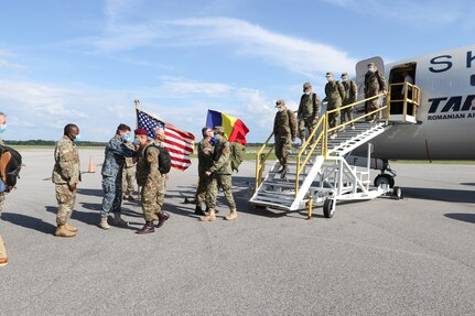 Florin Gheorghe IGNAT, assistant defense, military, naval, and air attaché, welcomes members of the Romanian Ministry of National Defense to Montgomery, Alabama, May 25, 2020. The Romanian team is assisting the Alabama National Guard in COVID-19 response as part of the National Guard's State Partnership Program.