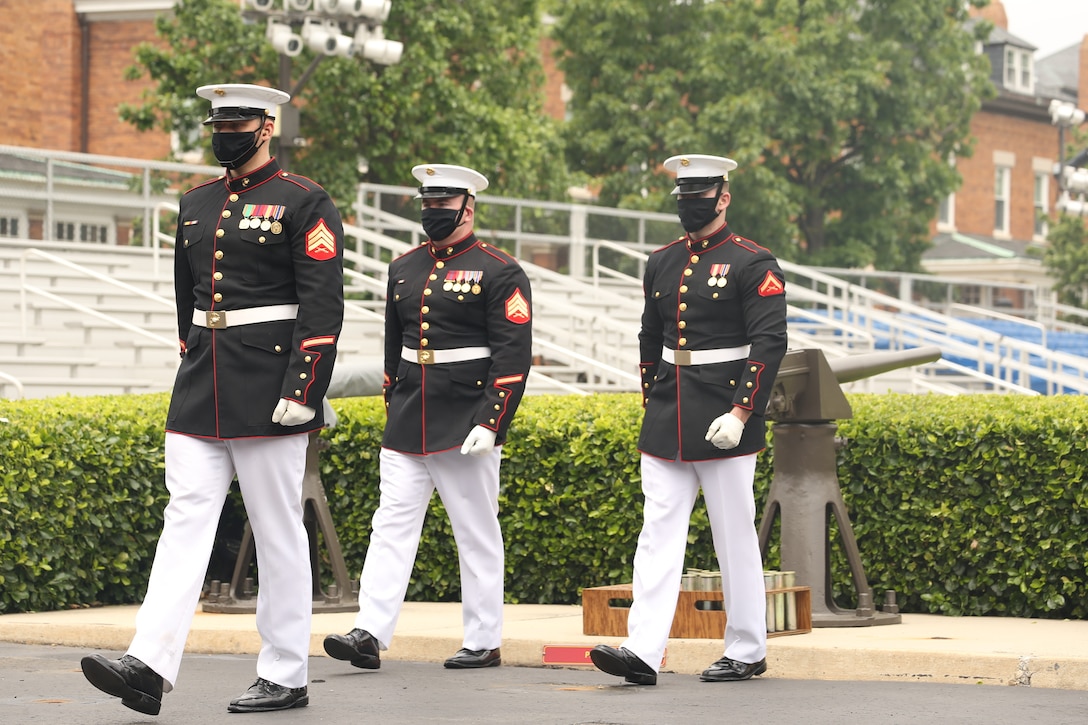 Body Bearers with Bravo Company, Marine Barracks Washington, march off the parade deck at Marine Barracks Washington, D.C., May 26, 2020. The Body Bearers fired a cannon every minute for 21 minutes in observance of Memorial Day. (U.S. Marine Corps photo by Lance Cpl. Allen Sanders.)