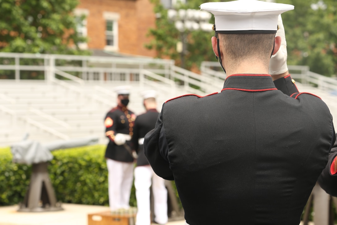 Body Bearers with Bravo Company, Marine Barracks Washington, fire a cannon on the parade deck at Marine Barracks Washington, D.C., May 26, 2020. The Body Bearers fired a cannon every minute for 21 minutes in observance of Memorial Day. (U.S. Marine Corps photo by Lance Cpl. Allen Sanders.)
