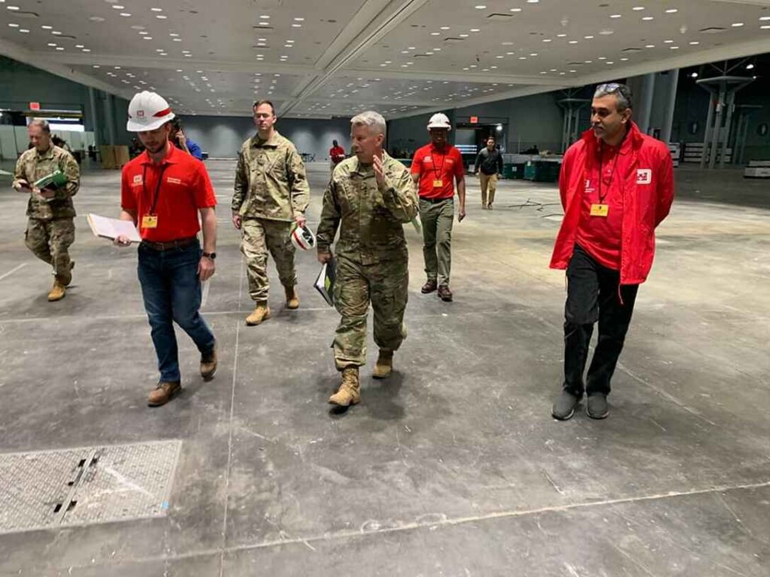 U.S. Army Corps of Engineers Commanding General and 54th U.S. Army Chief of Engineers Lt. Gen. Todd T. Semonite and U.S. Army Engineer Research and Development Center’s Cold Regions Research and Engineering Laboratory Research Associate Army 1st Lt. Eoghan Matthews walk through the Jacob K. Javits Convention Center in New York, New York, March 26, 2020. The Javits Center is being used as an alternative care facility and was assembled by USACE to provide additional support during the COVID-19 outbreak.