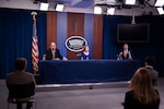 Three people at a desk