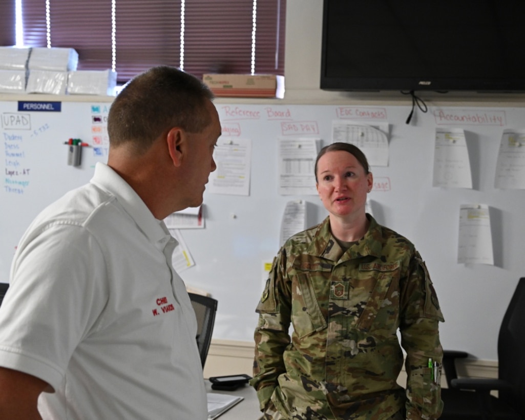 U.S. Air Force Senior Master Sgt. Stephanie Scott, 175th Wing Emergency Operations Center manager, speaks with Fire Chief Wayne Viands, 175th Emergency Operations Center manager, in the Emergency Operations Center at Warfield Air National Guard Base, Middle River, Md., May 21, 2020. The 175th Wing established the EOC during the states response to the COVID-19 pandemic. (U.S. Air National Guard photo by Master Sgt. Christopher Schepers)