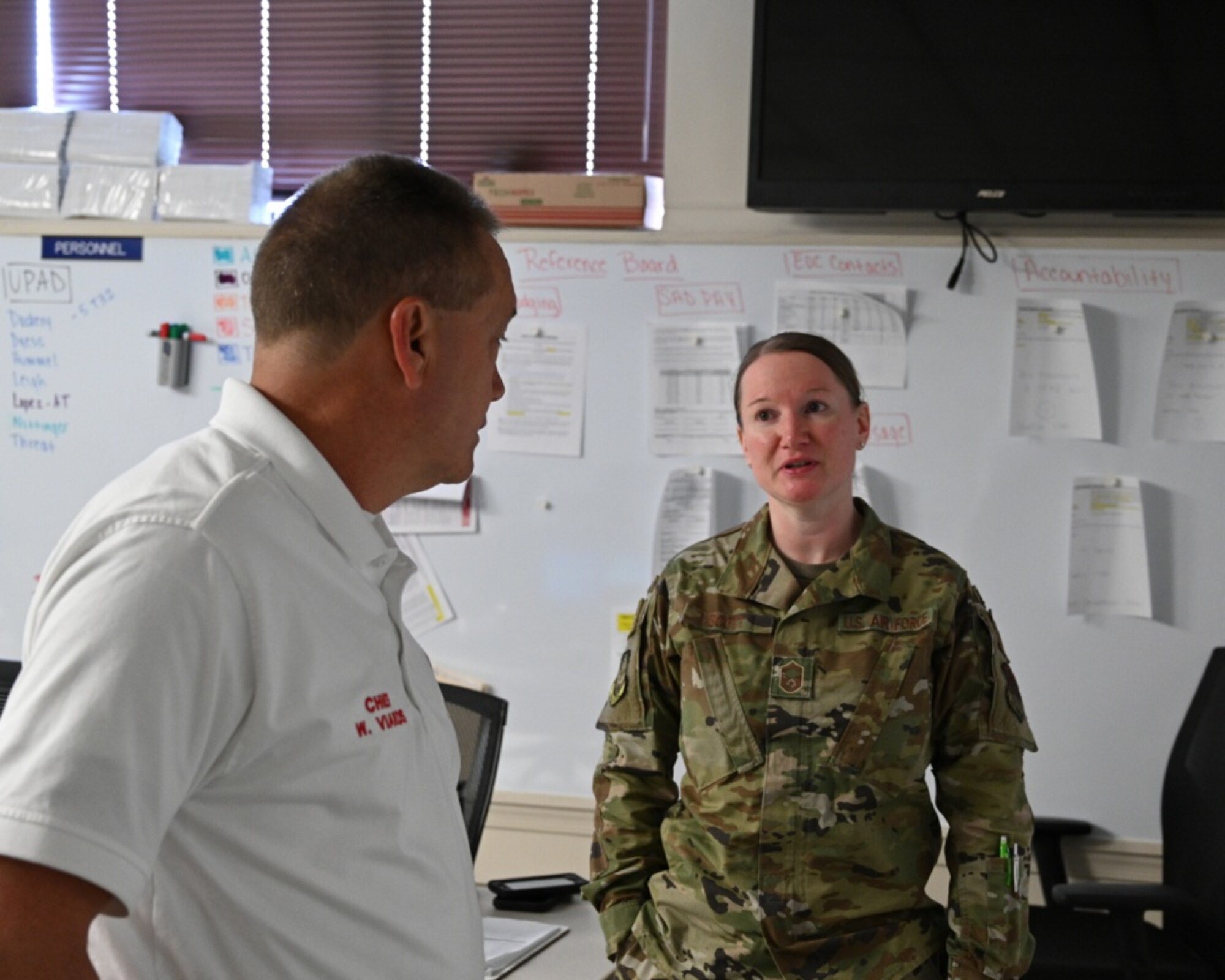 U.S. Air Force Senior Master Sgt. Stephanie Scott, 175th Wing Emergency Operations Center manager, speaks with Fire Chief Wayne Viands, 175th Emergency Operations Center manager, in the Emergency Operations Center at Warfield Air National Guard Base, Middle River, Md., May 21, 2020. The 175th Wing established the EOC during the states response to the COVID-19 pandemic. (U.S. Air National Guard photo by Master Sgt. Christopher Schepers)