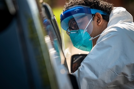 An Airman assigned to the West Virginia National Guard’s Task Force provides a COVID-19 test to a local citizen on May 22, 2020 in Charleston, W.Va. The WVNG's Chemical, Biological, Radiological, Nuclear and Explosive (CBRNE) Battalion, the 35th Civil Support Team (CST), and the 35th Enhanced Response Force Package (CERFP), which make up Task Force CRE, and Task Force Medical personnel are highly trained in operating in a "contaminated environment" and have conducted more than 3,000 tests for COVID-19 in 87 lane support missions since the beginning of our response 70 days ago. (U.S. Air National Guard Photo by Staff Sgt. Caleb Vance)