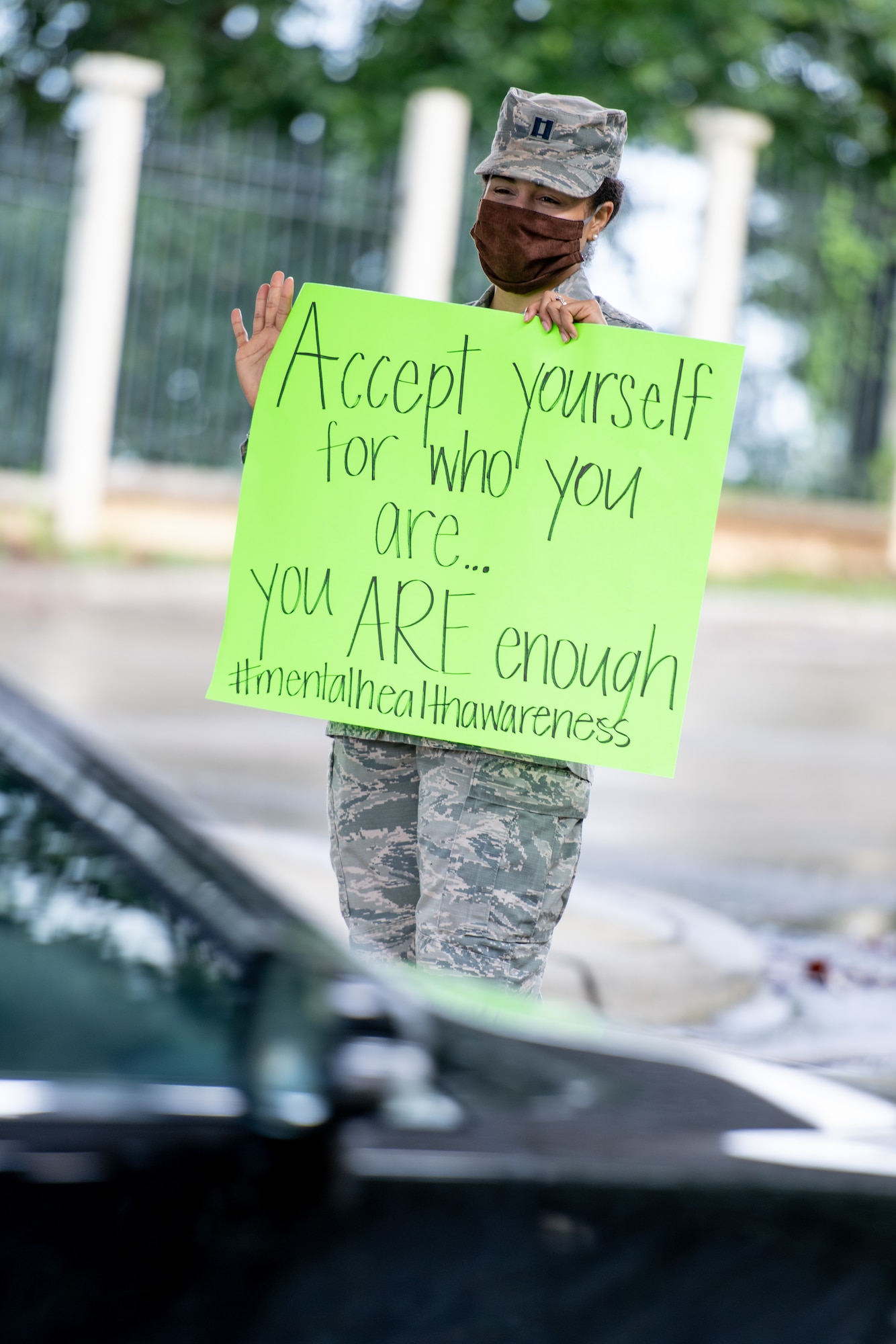 Airman hold signs up outside the Day Street gate.