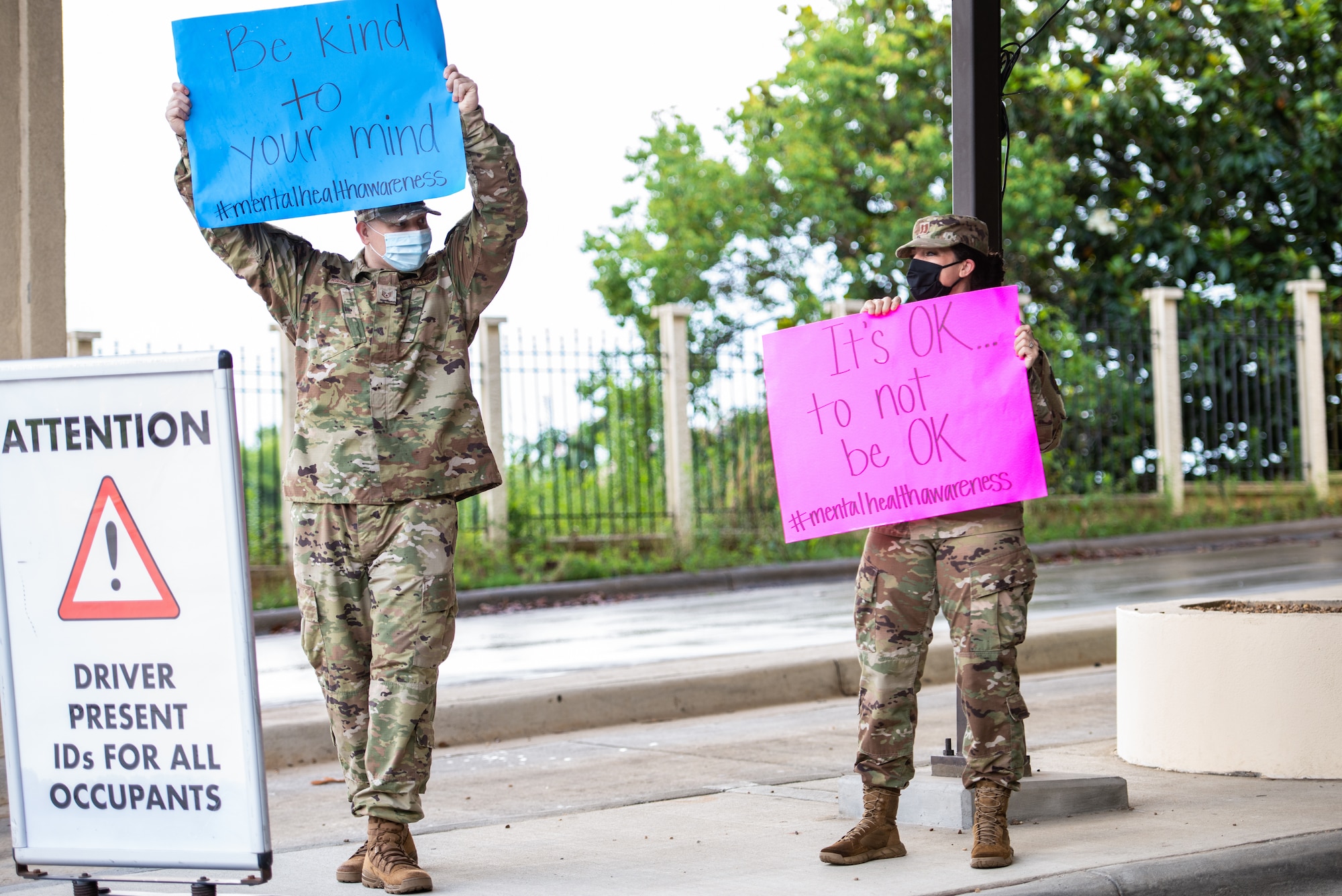 two Airman hold signs up outside the Day Street gate.