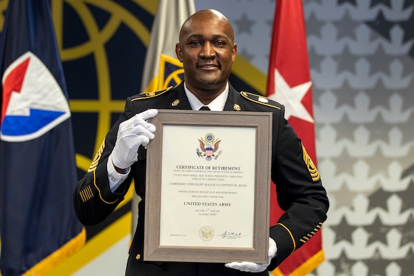 Command Sgt. Maj. Courtney M. Ross, U.S. Army Financial Management Command senior enlisted advisor, grins as he shows off his certificate of retirement during a ceremony at the Maj. Gen. Emmett J. Bean Federal Center in Indianapolis May 15, 2020. Ross, a native of North Augusta, South Carolina, joined the Army as an accounting specialist in 1996. (U.S. Army photo by Mark R. W. Orders-Woempner)