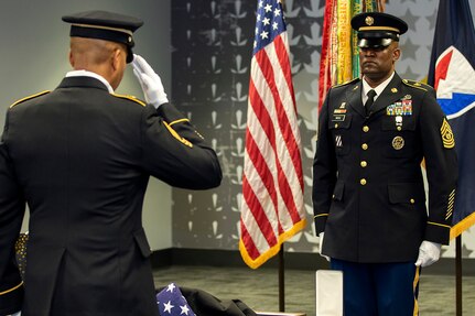 Master Sgt. L. Alphanzo Hunter, U.S. Army Financial Management Command Operations noncommissioned officer, salutes a U.S. flag after presenting it to Command Sgt. Maj. Courtney M. Ross, USAFMCOM senior enlisted advisor, during Ross’ retirement ceremony at the Maj. Gen. Emmett J. Bean Federal Center in Indianapolis May 15, 2020. Ross retired after more than 24 years of military service. (U.S. Army photo by Mark R. W. Orders-Woempner)