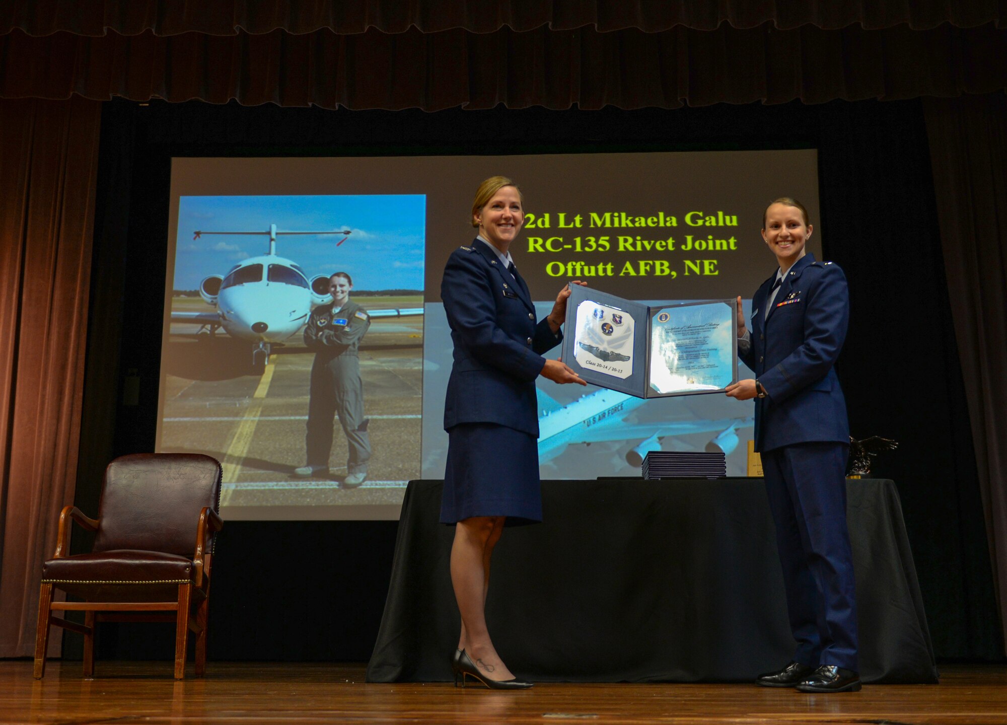 Col. Samantha Weeks, former 14th Flying Training Wing commander, hands a certificate to 2nd Lt. Mikaela Galu, Specialized Undergraduate Training Class 20-14/15 graduate, on May 15, 2020, at Columbus Air Force Base, Miss. In order to graduate from SUPT at Columbus AFB students must conduct over 52 weeks of training. (U.S. Air Force photo by Airman 1st Class Davis Donaldson)