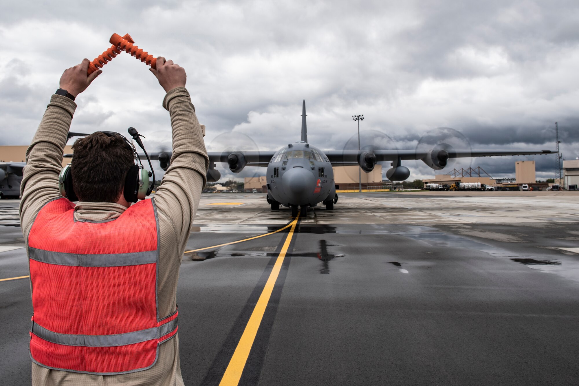 Airman 1st Class Eric Walker, 911th Aircraft Maintenance Squadron crew chief, marshalls a C-130 Hercules assigned to the 910th Airlift Wing to a parking spot at the Pittsburgh International Airport Air Reserve Station, Pennsylvania, April 30, 2020.