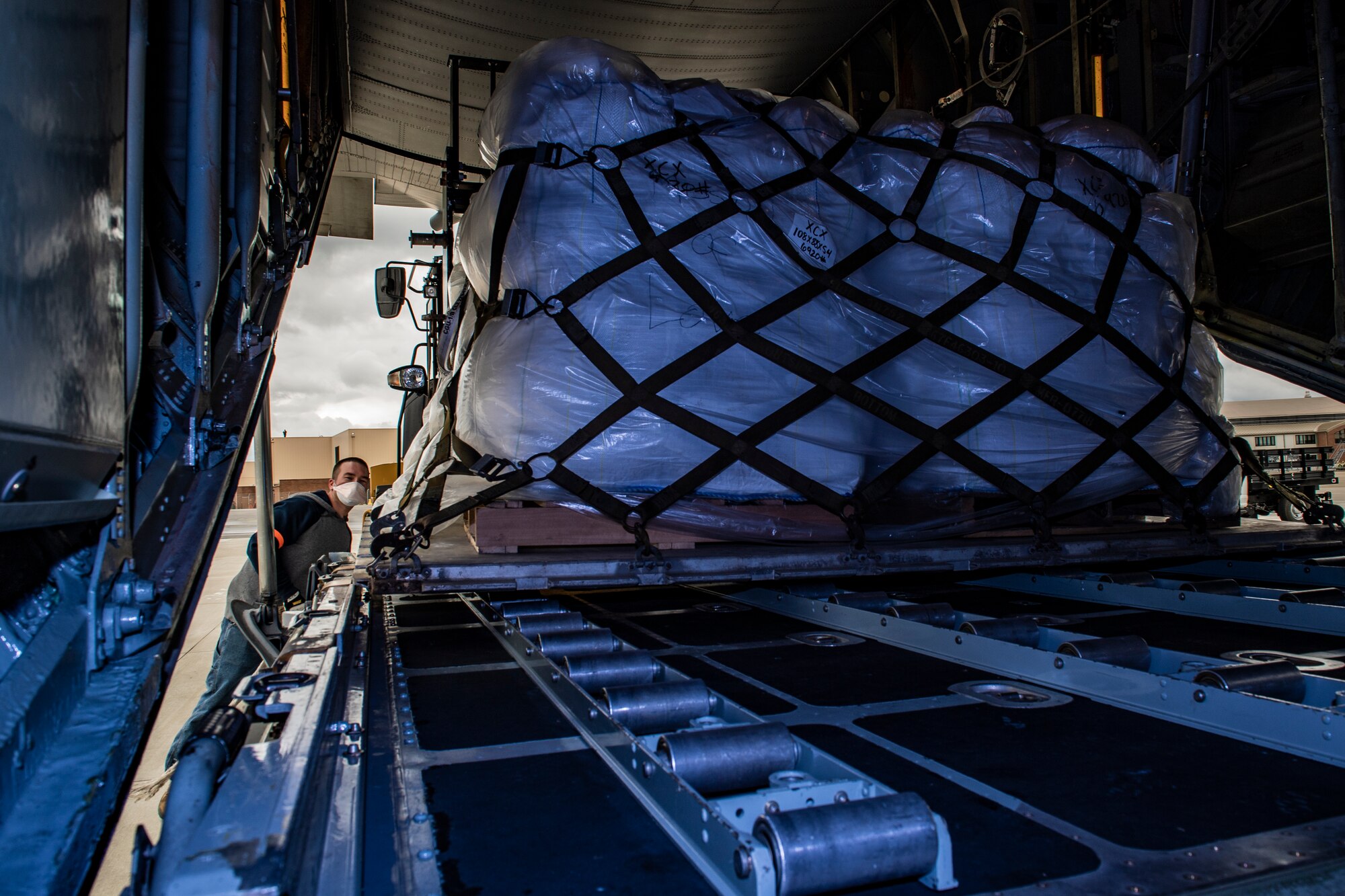 Lance Cooper, a contractor working with the 911th Logistics Readiness Squadron, watches as cargo is loaded onto a C-130 Hercules assigned to the 910th Airlift Wing at the Pittsburgh International Airport Air Reserve Station, Pennsylvania, April 30, 2020.