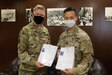 U.S. Army Col. Ian Black, command surgeon for the 1st Theater Sustainment Command, left, and U.S. Army Capt. Yusheng Chen, command dentist for Area Support Group - Kuwait, present their Kuwaiti medical-licenses at the Kuwait Armed Forces Hospital in Sabah Al Salem, Kuwait, May 19, 2020. Black and Chen are the first U.S. military personnel to be medically licensed for practice in Kuwait, an initial step towards medical interoperability between the two nations. (U.S. Army photo by Sgt. Sean Harding)