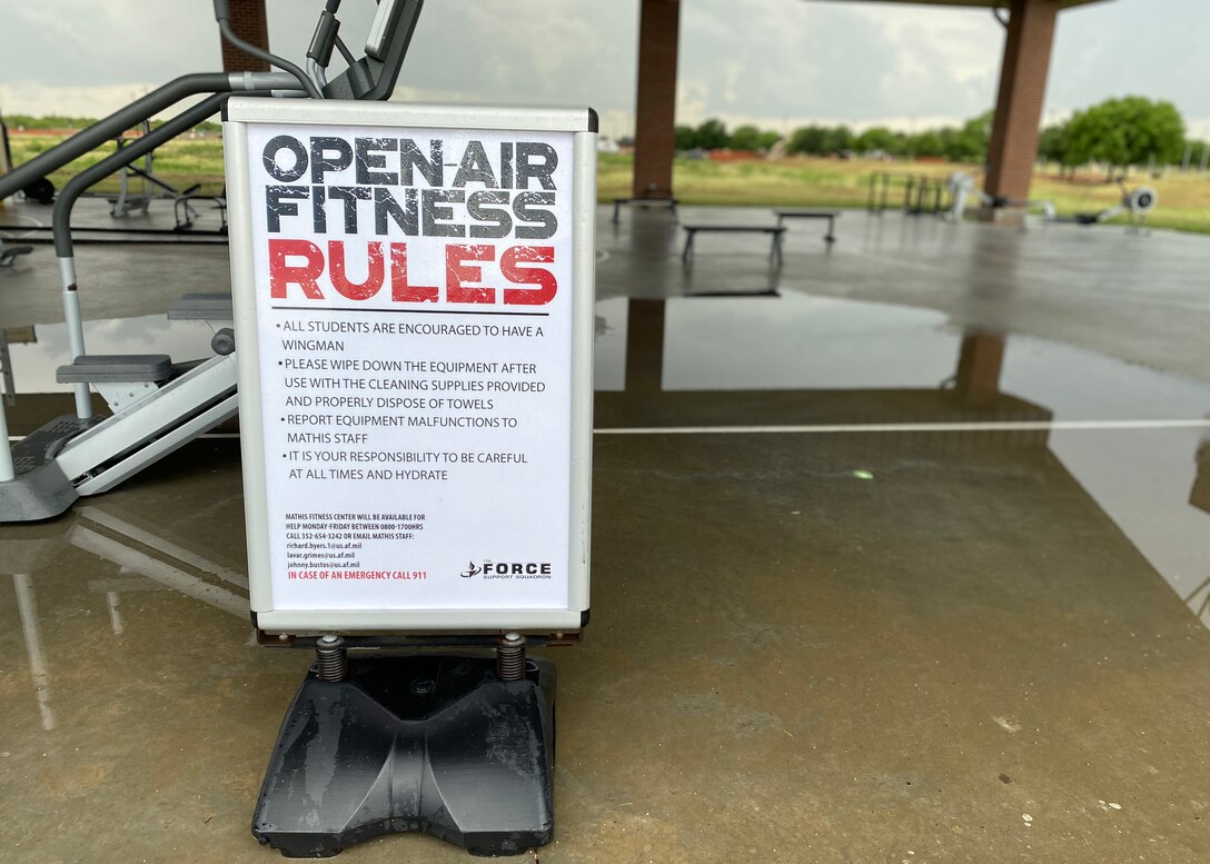 The rules to the  Mathis Fitness Center’s outdoor facilities are on display, on Goodfellow Air Force Base, Texas, May 28, 2020.  The staff  intentionally spaced the equipment to enforce a six-foot-social-distance and provided cleaning towels and spray bottles to sanitize the machines after each use. (U.S. Air Force photo by Airman 1st Class Abbey Rieves)