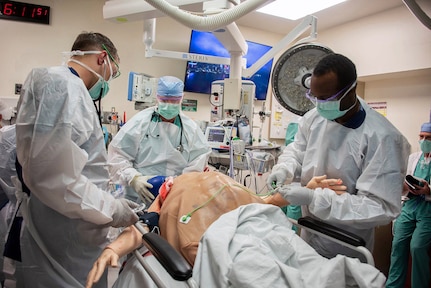 Members of the 555th Forward Surgical Team assess a simulated trauma patient