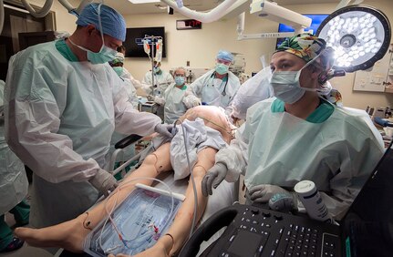 Members of the 555th Forward Surgical Team assess a simulated trauma patient during training with the Strategic Trauma Readiness Center of San Antonio, or STaRC, at Brooke Army Medical Center, Joint Base San Antonio-Fort Sam Houston May 28. T