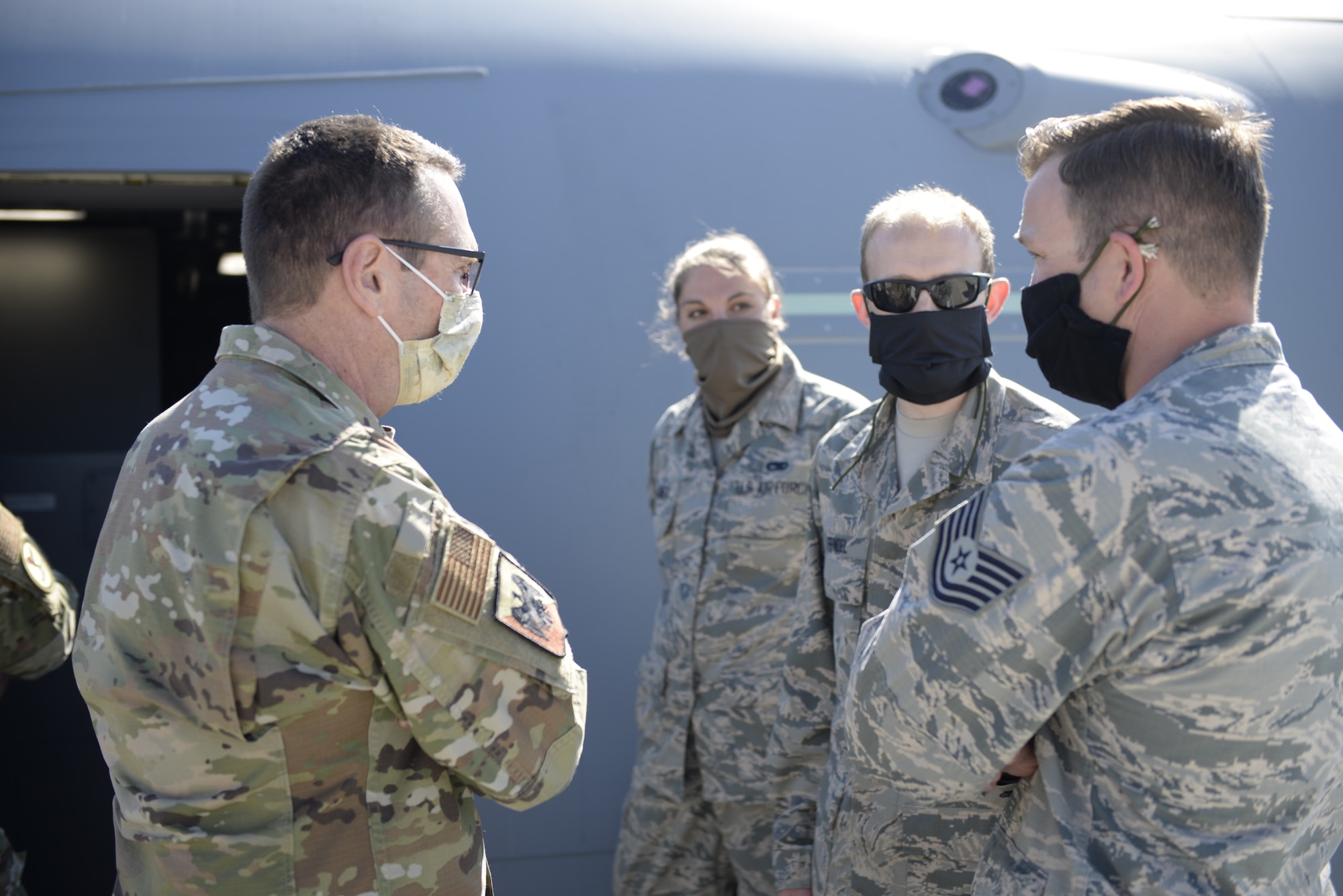 Gen. Joseph L. Lengyel, the Chief of the National Guard Bureau, talks with (from left to right) Senior Airman Kayla Orner, Tech. Sgt. Ariel Feindel and Tech. Sgt. Nicholas Johnston at Pease Air National Guard Base, Newington, N.H., May 27, 2020. The general presented coins to the trio for outstanding performance. (U.S. Air National Guard photo by Senior Master Sgt. Timm Huffman)